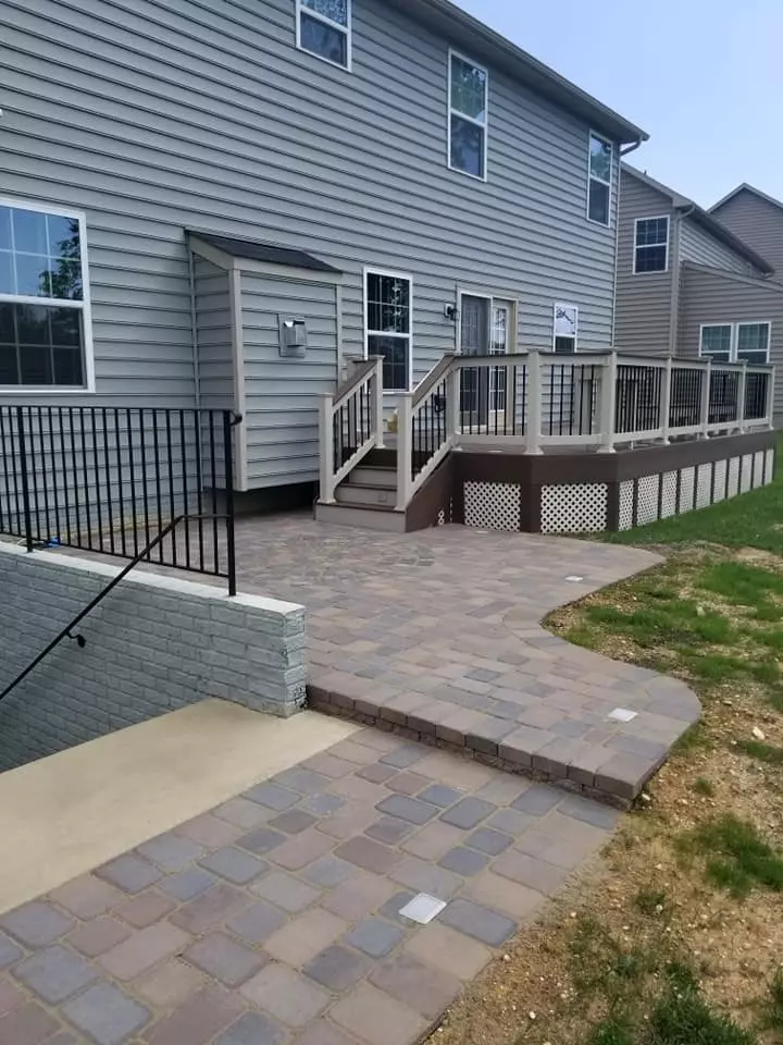 Raised deck with adjacent paver patio and steps