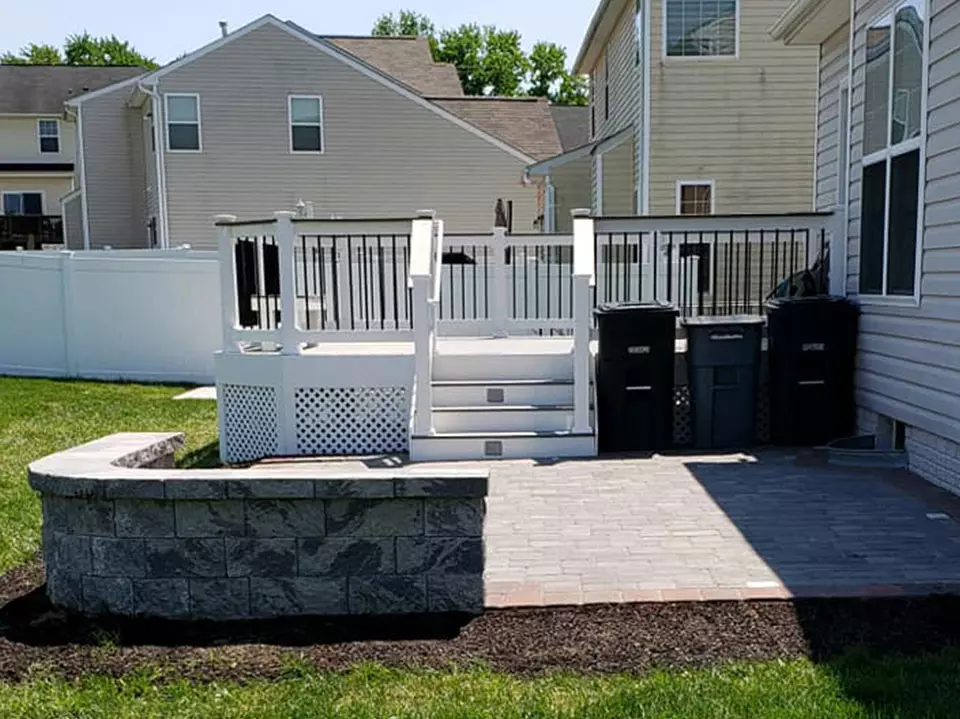 Small deck with paver patio and wall