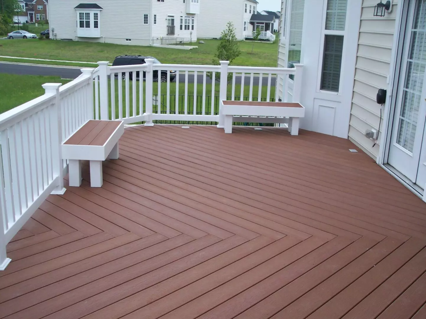 A white deck with a brown floor and benches