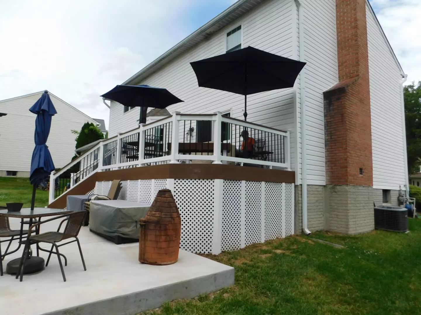 An elevated patio with three blue parasols