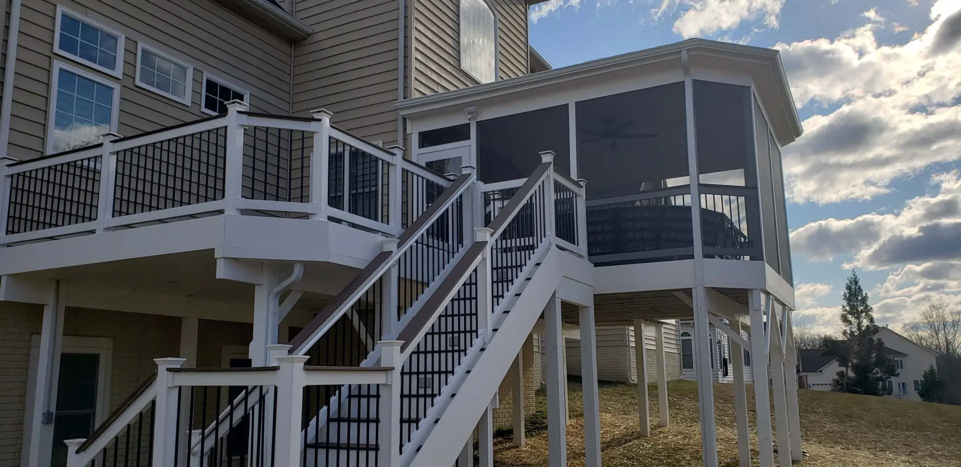 Elevated house with stairs leading to a screened porch.