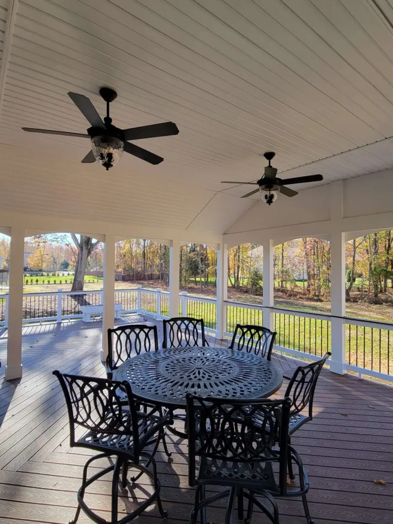 Spacious screened porch with ceiling fans and outdoor dining set.