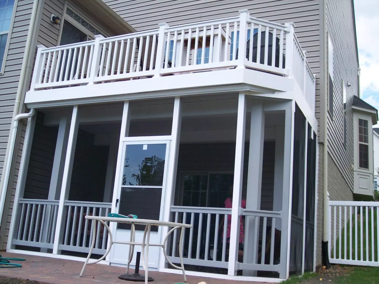 Elevated white wooden deck on top of an enclosed space