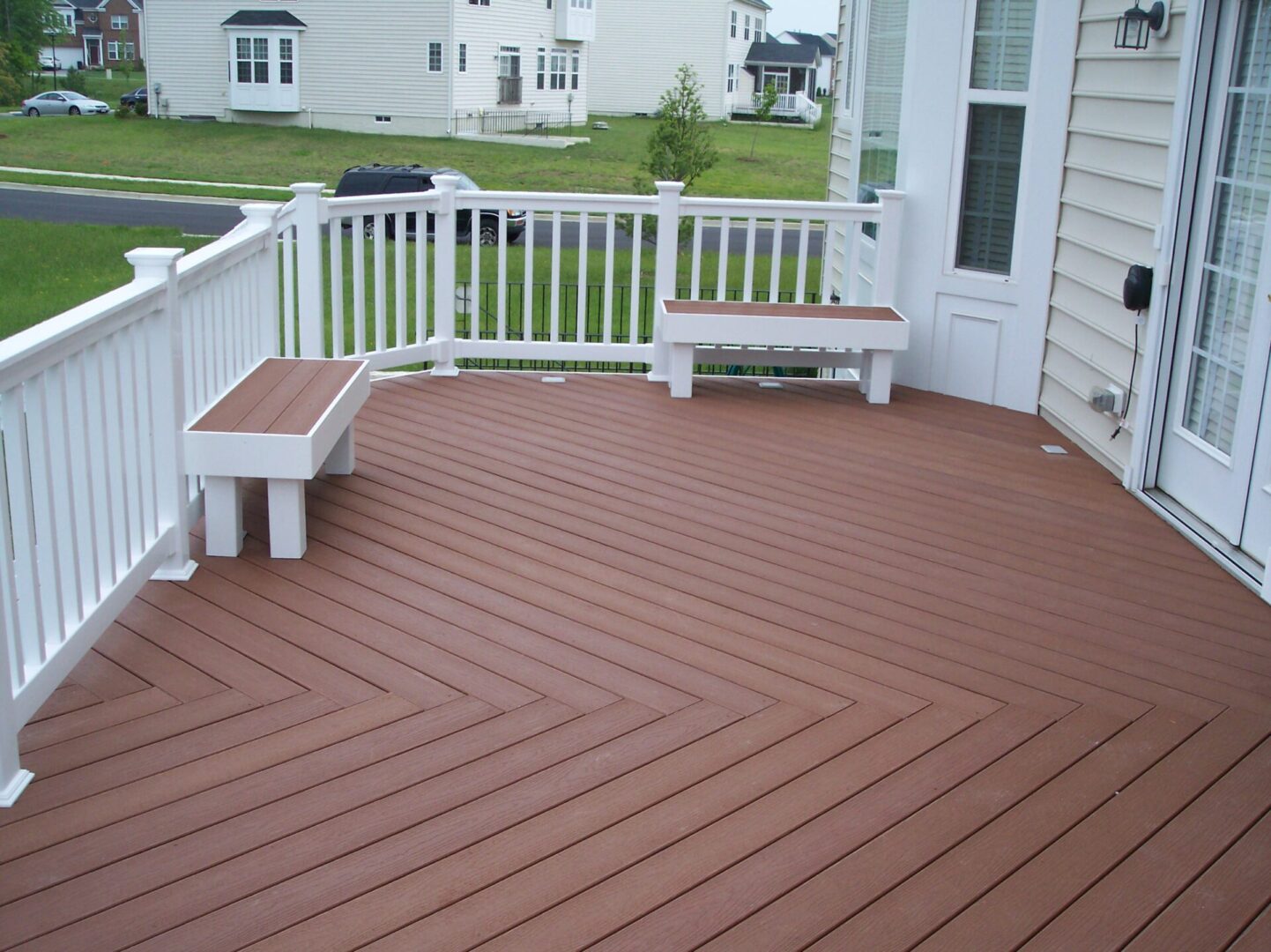 A white deck with a brown floor and benches