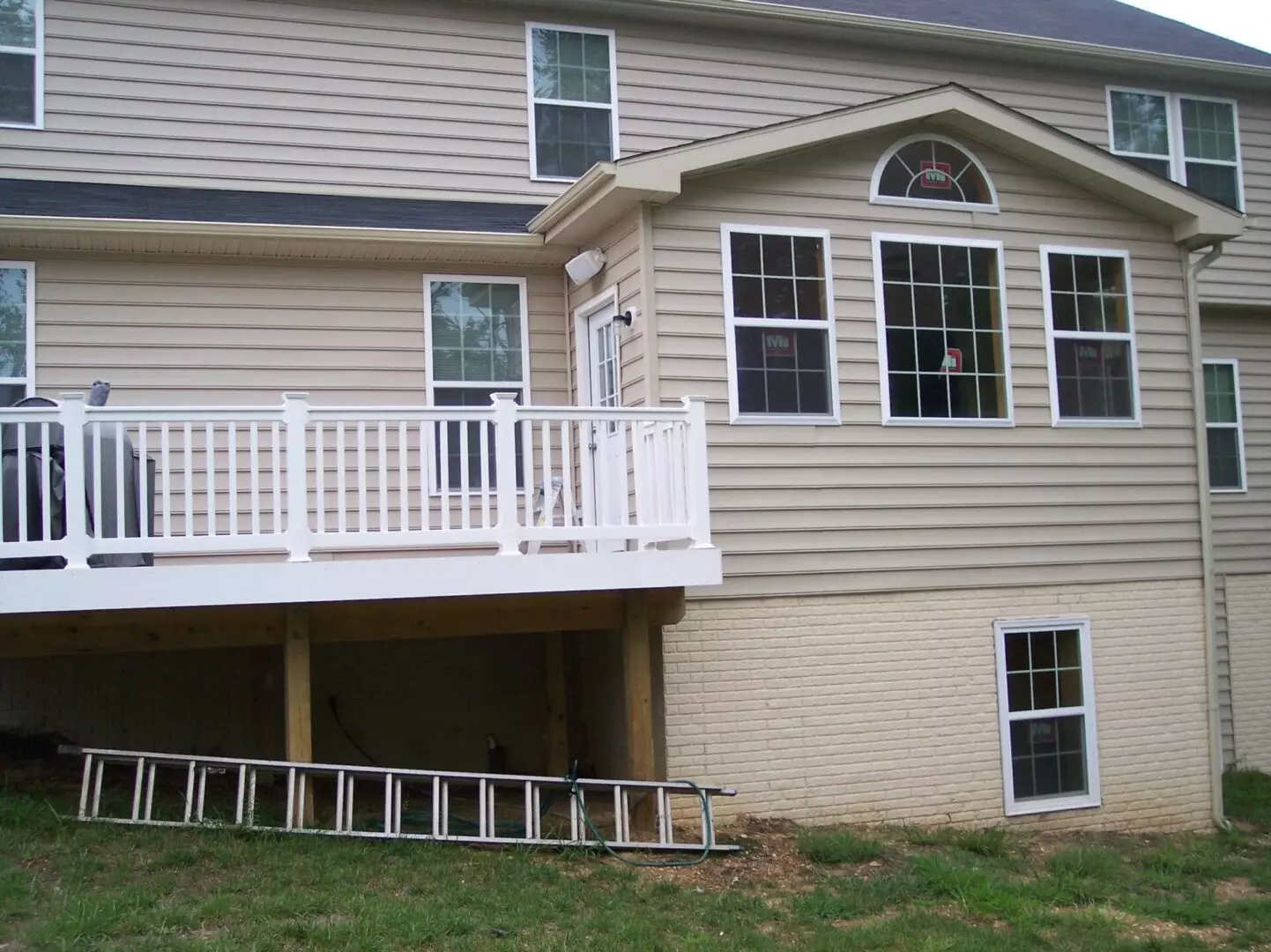 An elevated white deck attached to the side of a house