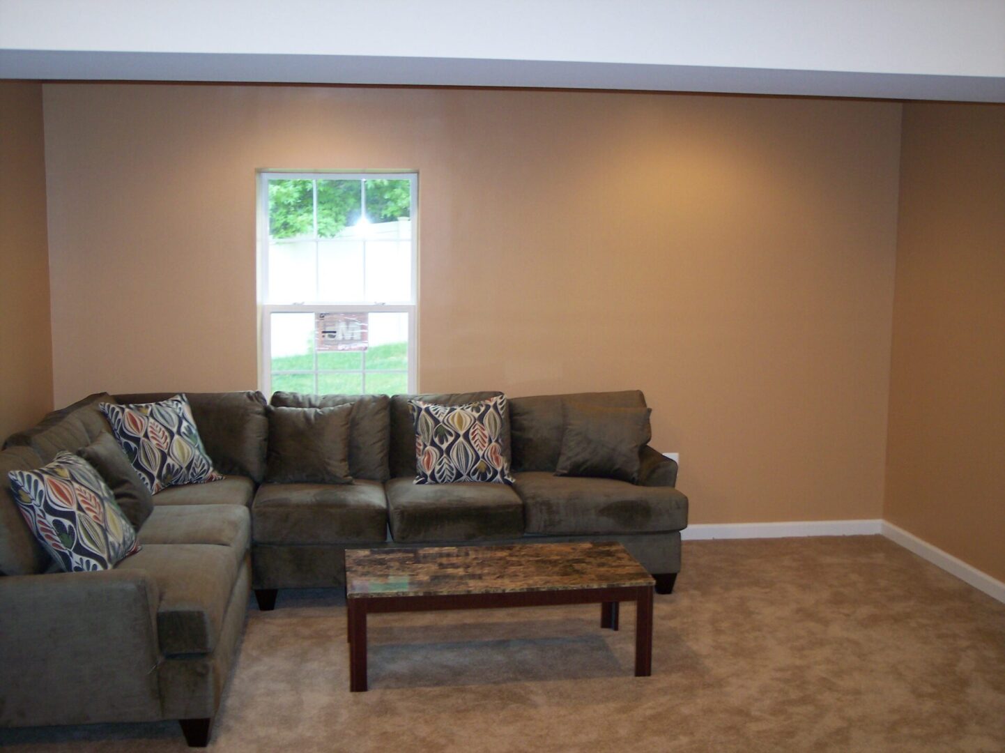 An indoor space with brown couches and coffee table
