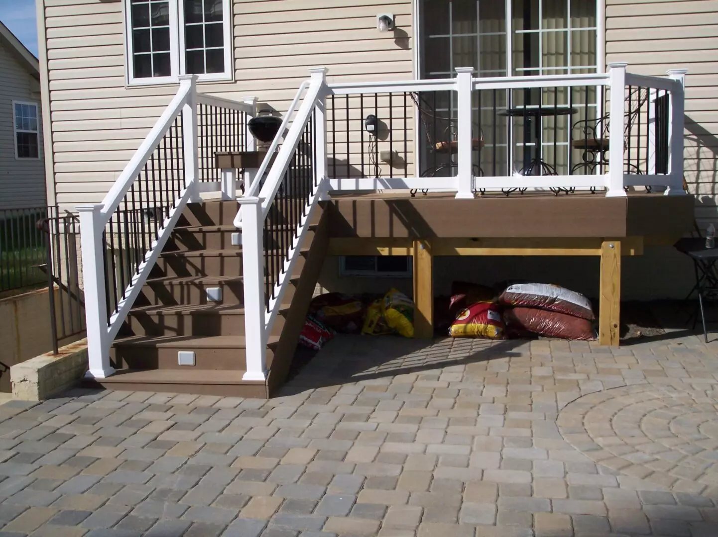 An elevated white porch with brown stairs